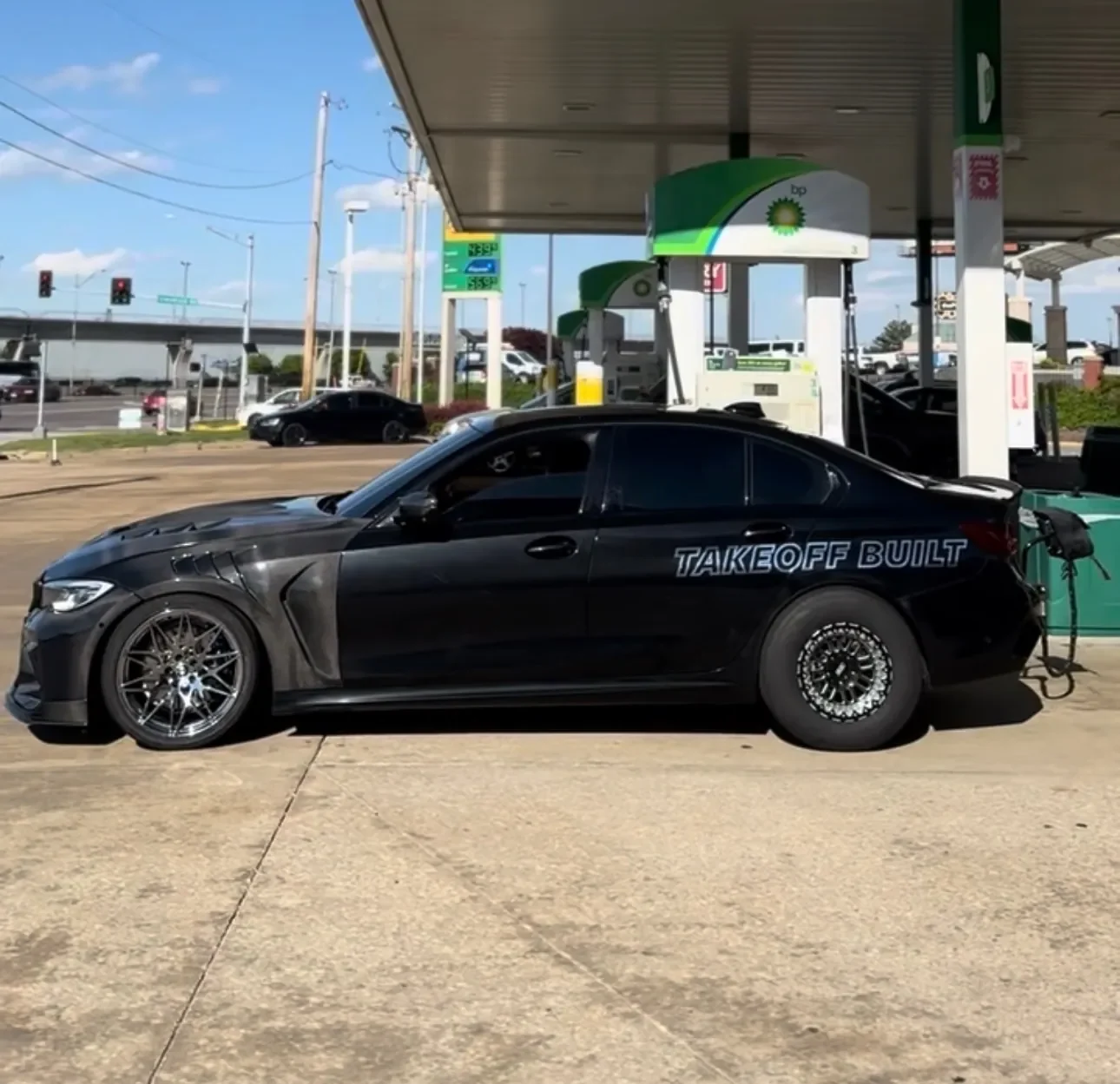 Black BMW M340i drag build in profile with carbon panels
