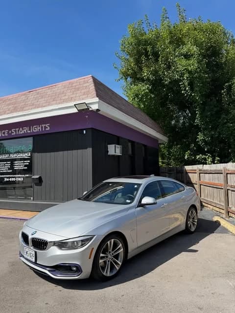 Silver BMW 430i outside the shop