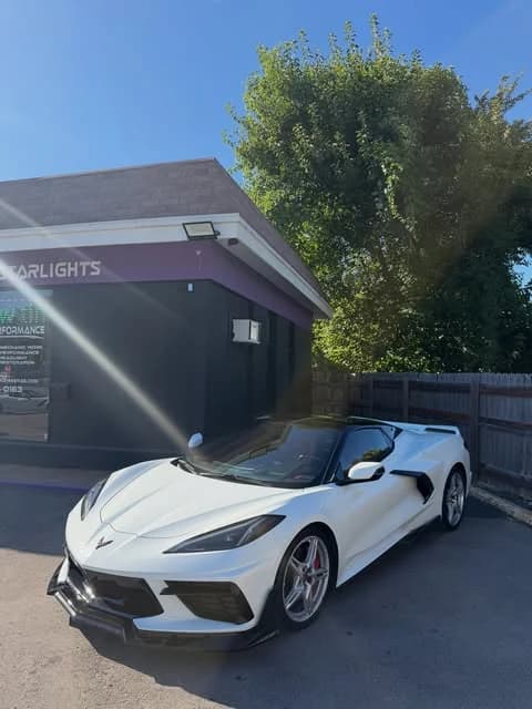 White C8 Corvette outside the shop