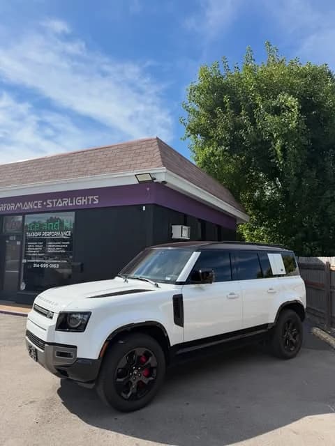 White Defender with red calipers