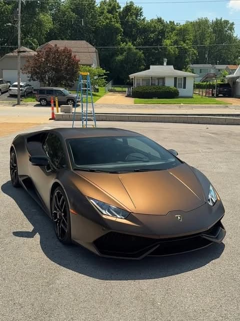 Bronze-wrapped Huracán in the shop lot