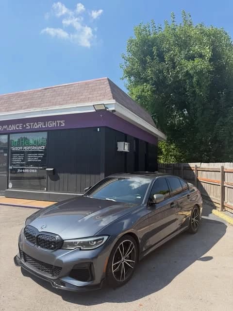Grey BMW M340i outside the shop